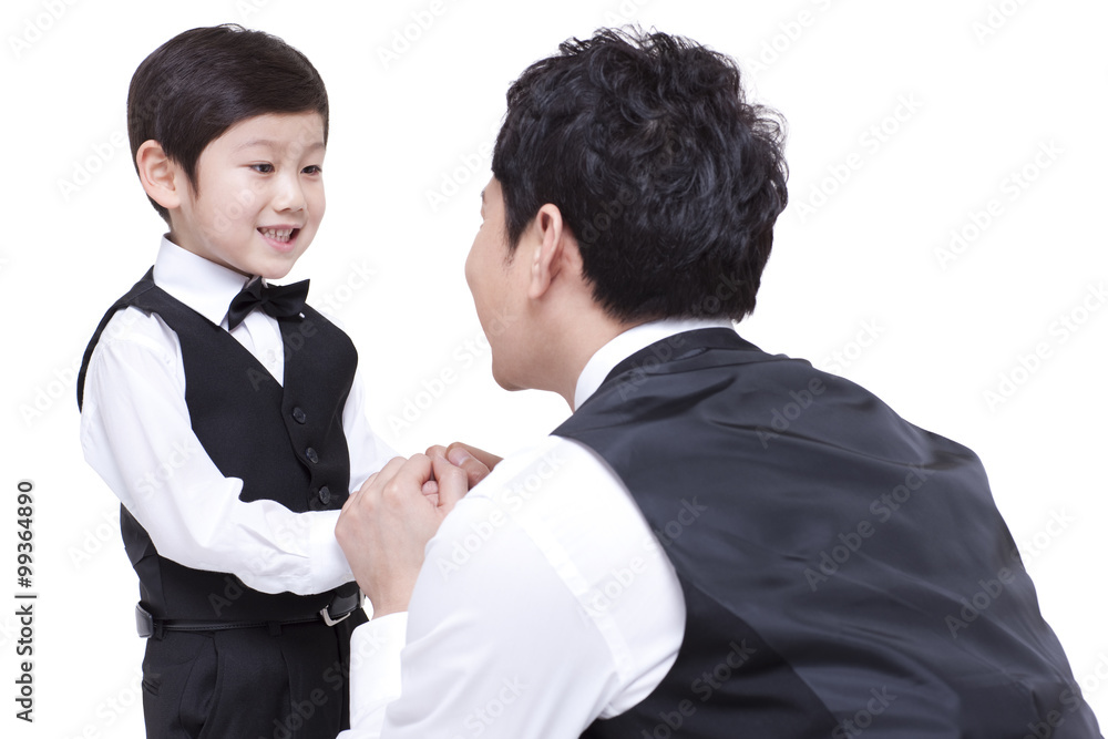 Young father holding hands with son