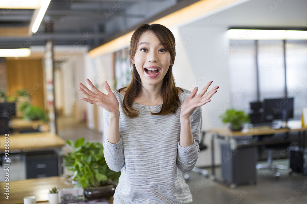 Young woman with surprised expression in office