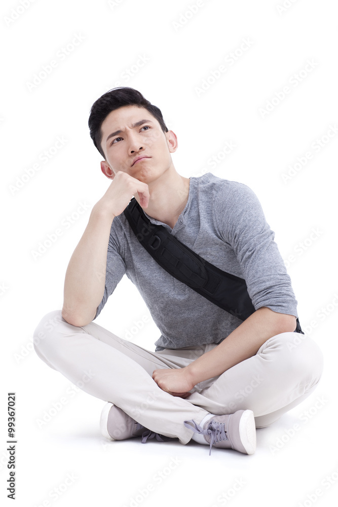 College male college student with hand on chin thinking