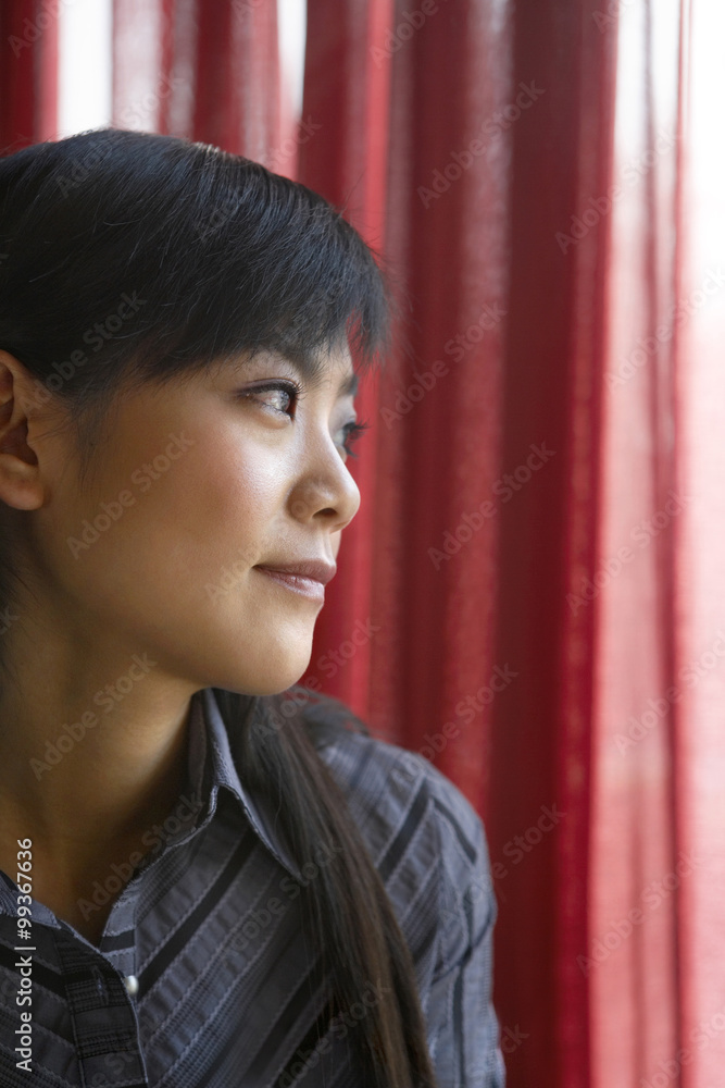 Woman Looking Out Of Window Contemplatively  