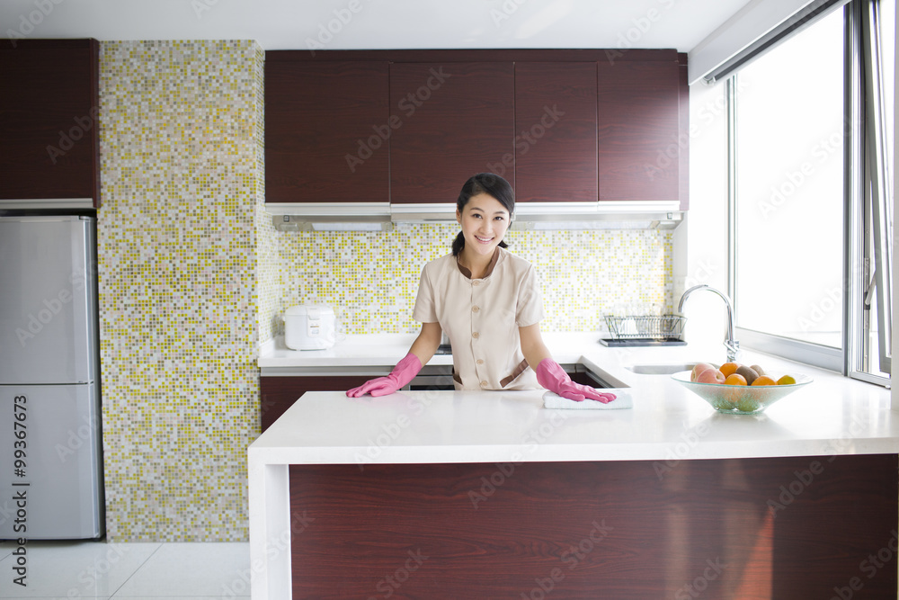 Domestic staff cleaning kitchen