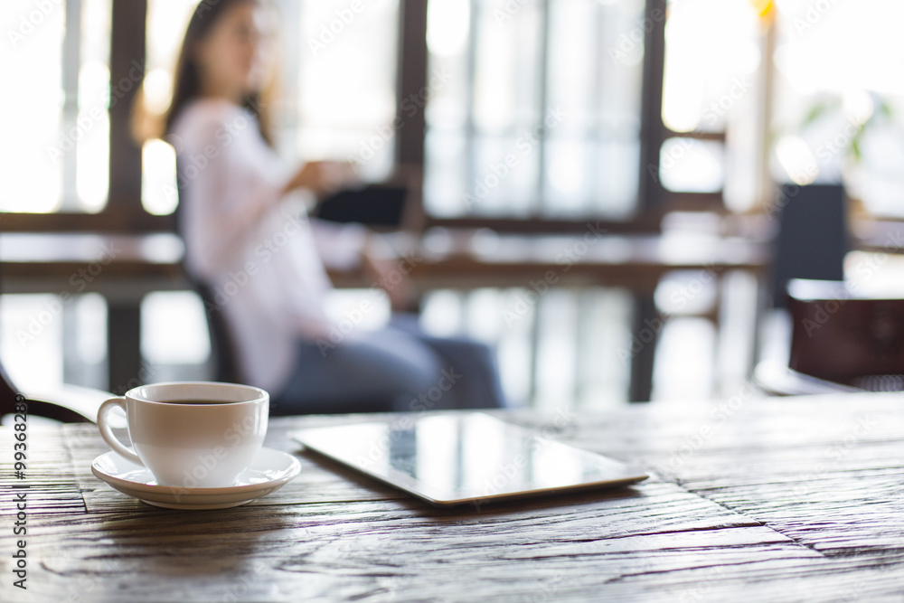 A cup of coffee and a digital tablet