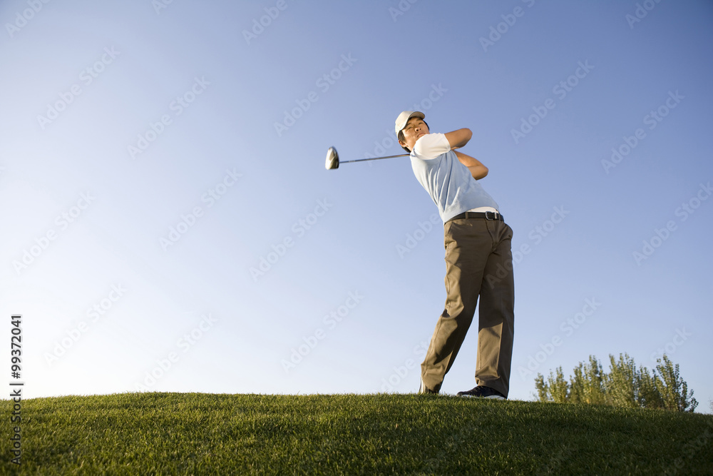 Golfer teeing off on the course