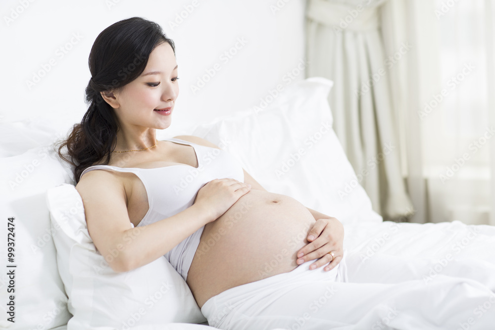 Pregnant woman resting in bed