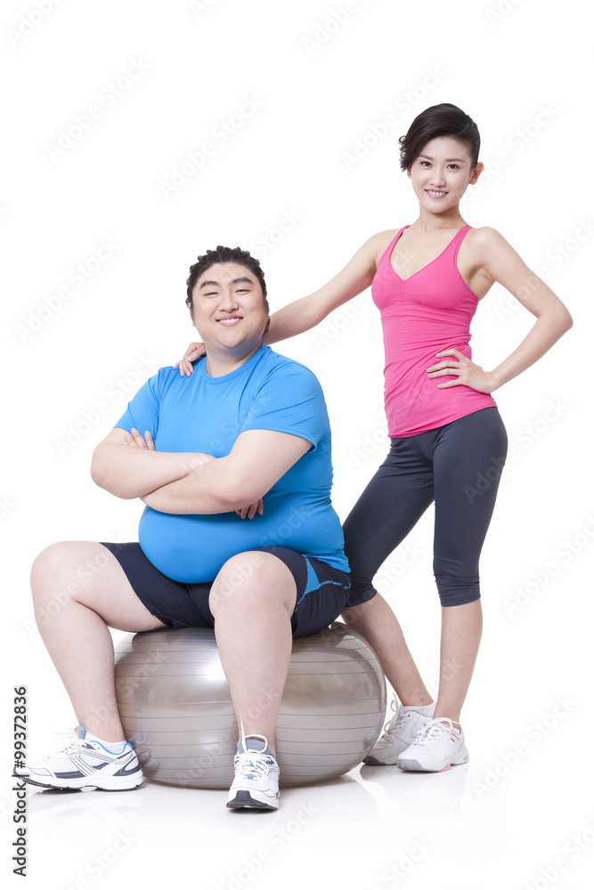 Happy Chubby man and girlfriend with fitness ball