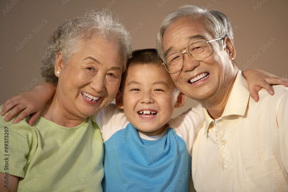 Grandparents And Their Grandson Smiling For A Photograph