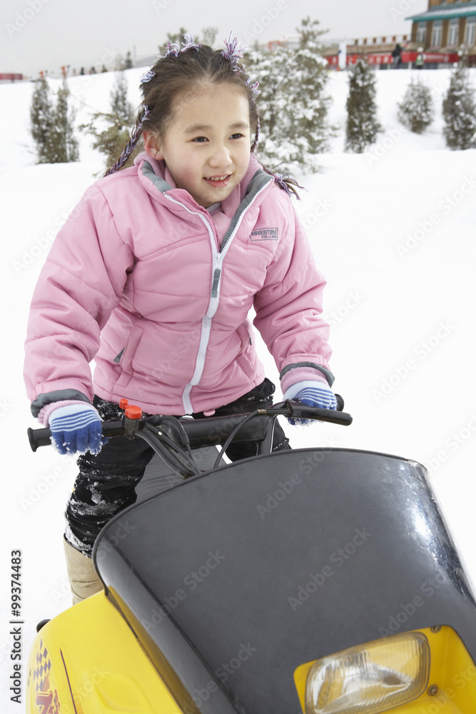 Young Girl Riding Snowmobile