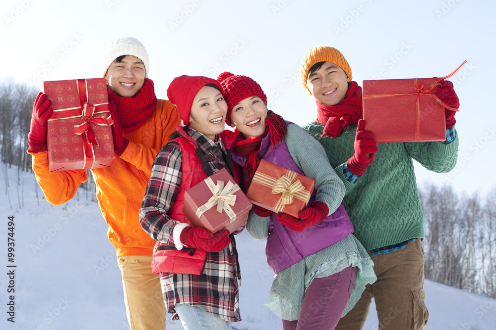 Young people holding gift boxes