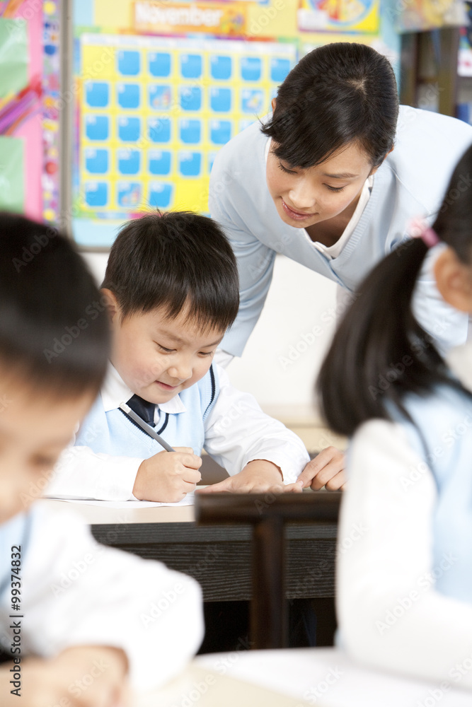 Teacher assisting student in class