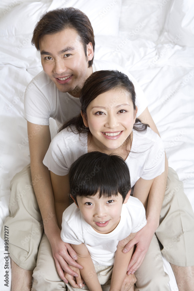 Portrait of a young family on a bed