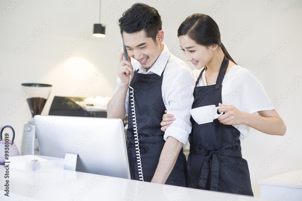 Young couple working in coffee shop