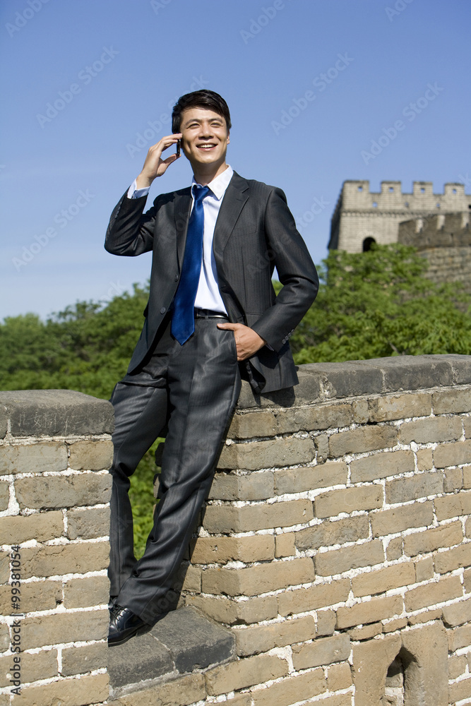 Businessman using a mobile phone on the Great Wall