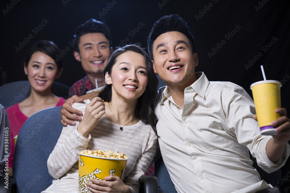 Young couple watching movie in cinema