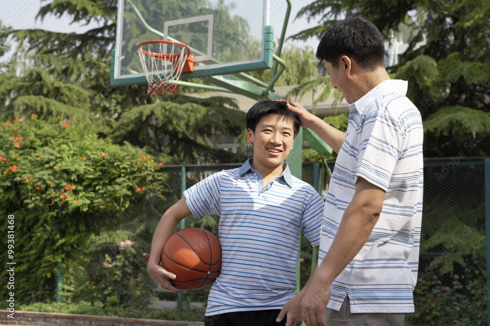 Father And Son On Basketball Court