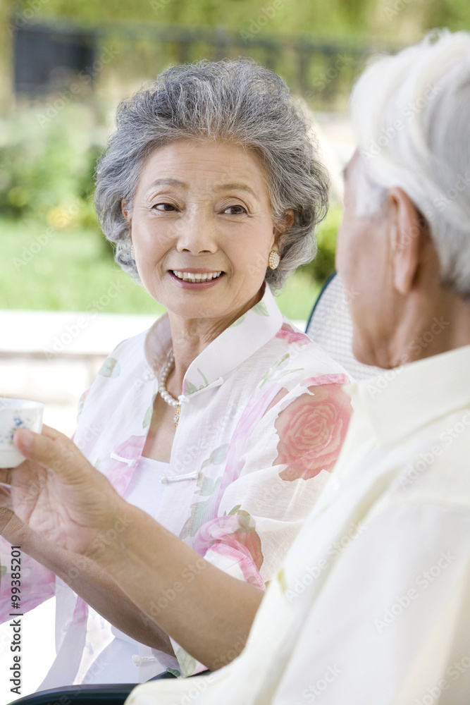 Senior couple chatting and having tea