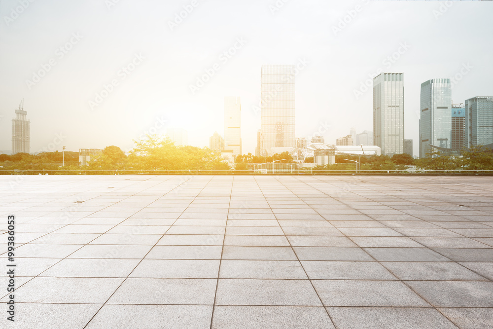 empty floor with backdrop on modern cityscape at sunrise time