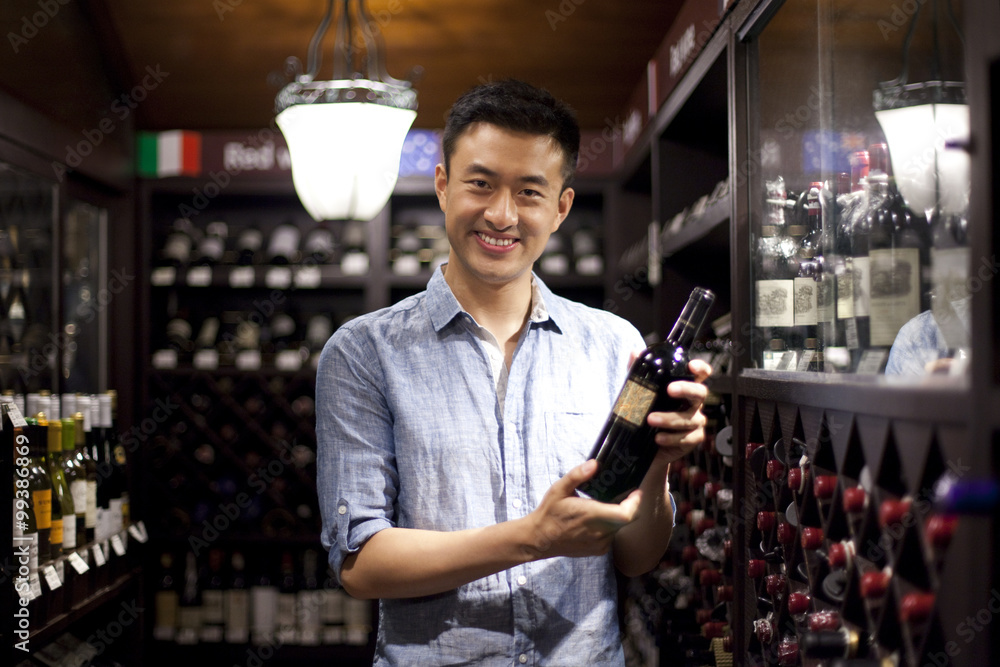 Young man shopping in cellar