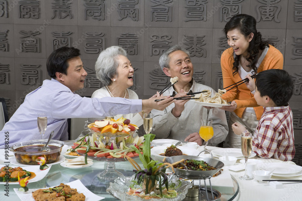 Mother serves dumplings to Grandparents, Husband and Son