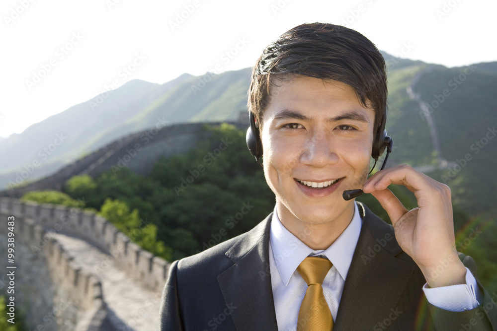 Businessman with headsets on the Great Wall