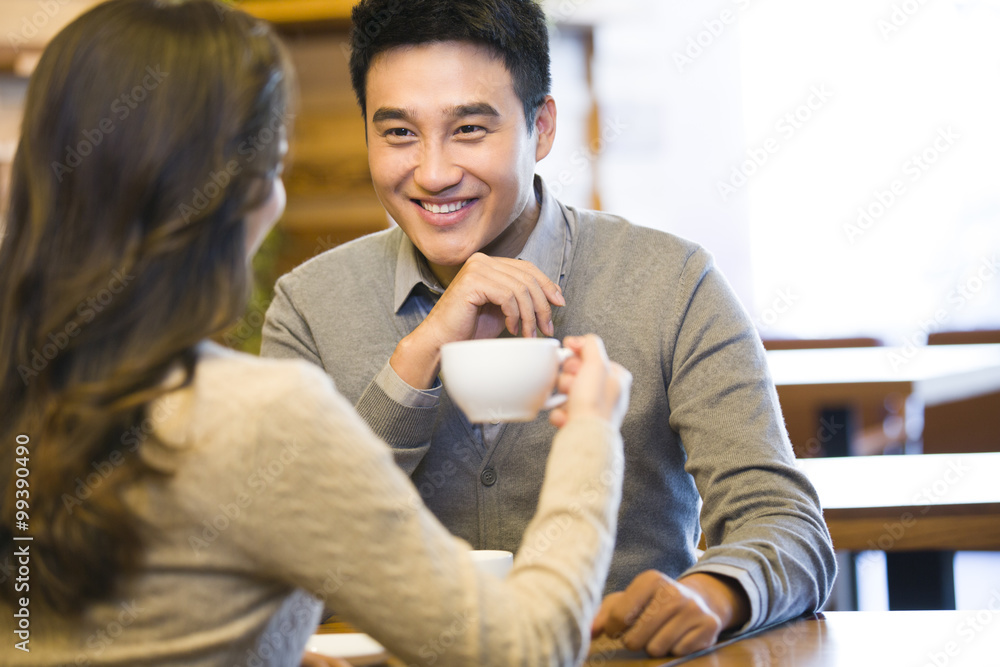 Young couple chatting in cafe