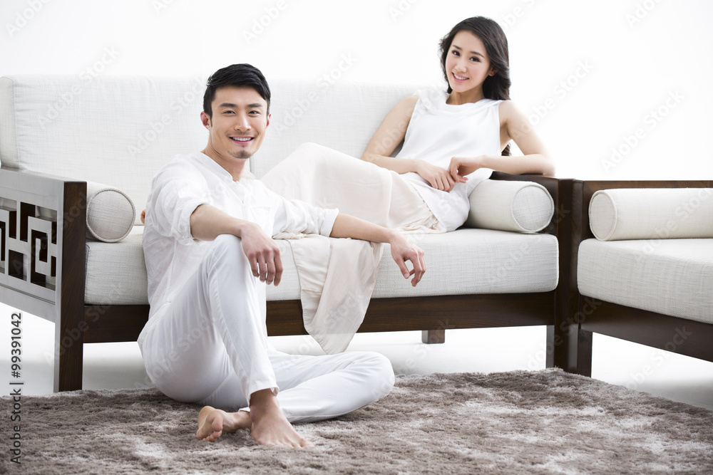 Happy young couple relaxing at home