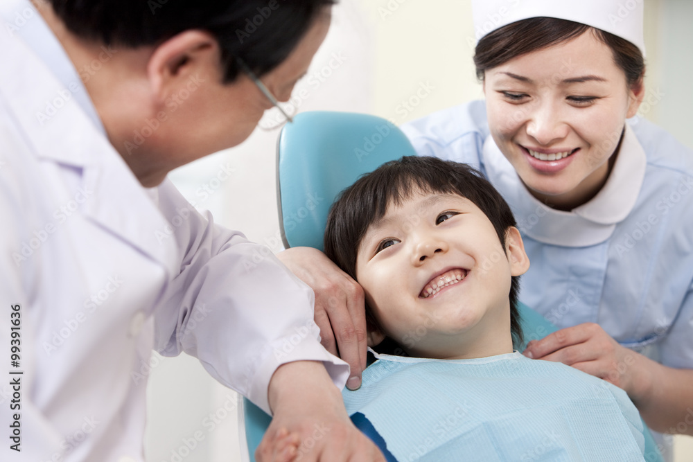 Little patient receiving treatment in dental clinic