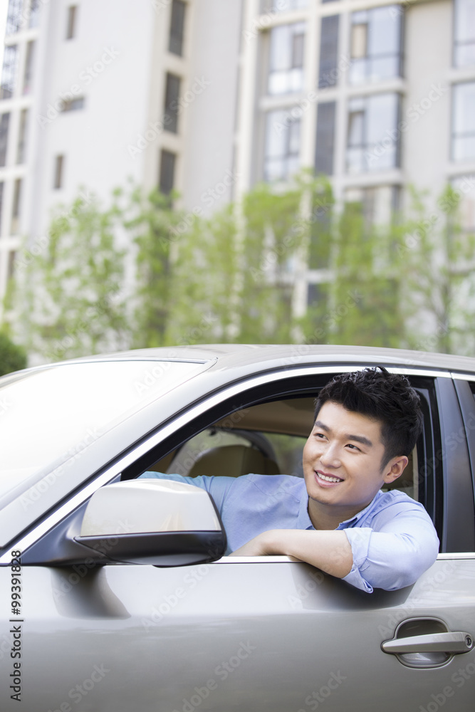 Young man driving car