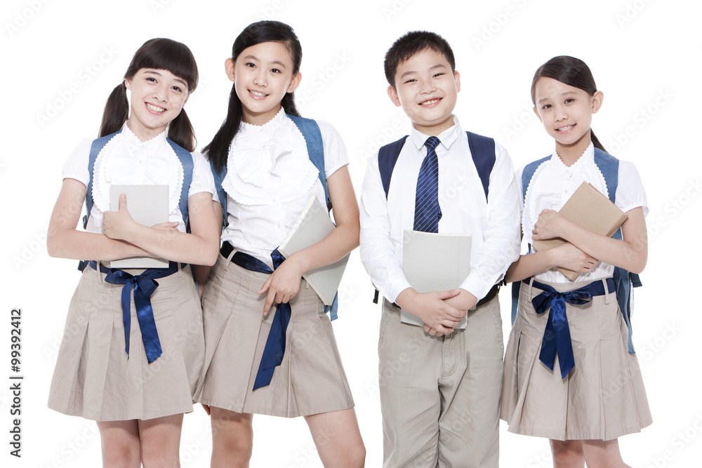 Happy primary school friends with books and schoolbags