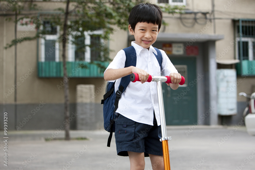 Boy on a push scooter