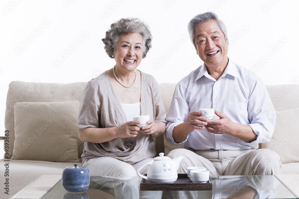 Cheerful senior couple having tea