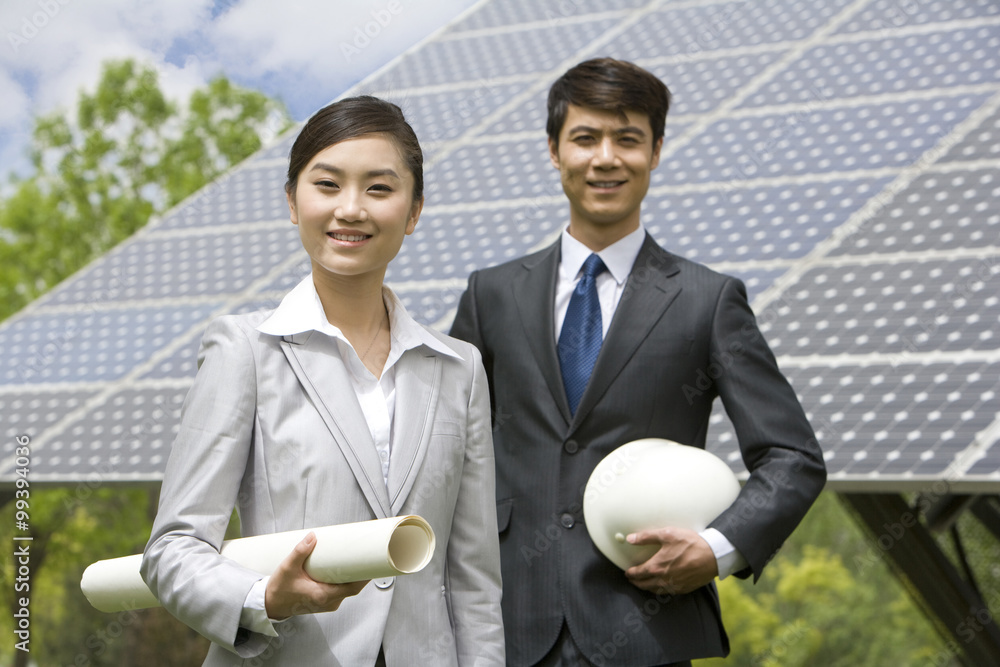 Two engineers in front of solar panels