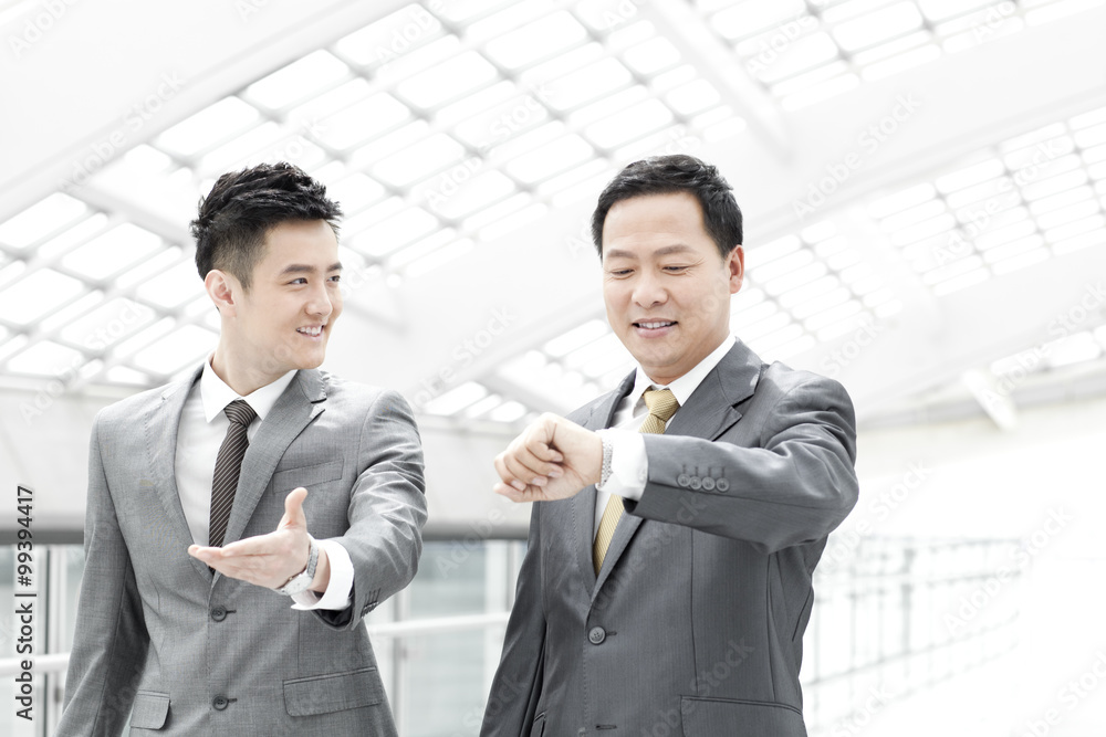 Business people checking the time in airport lobby