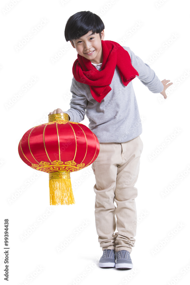 Cheerful boy with red lantern celebrating Chinese New Year