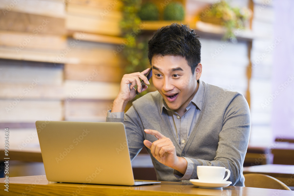 Young man on the phone in coffee shop