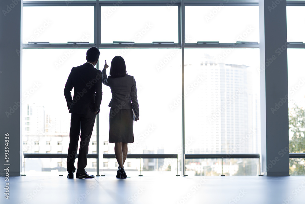 Business person looking through window