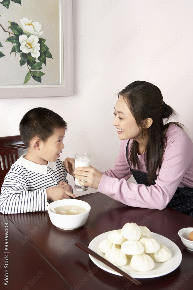 母亲给儿子一杯牛奶