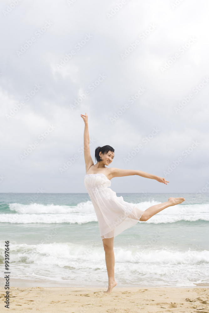 A woman dancing at the beach