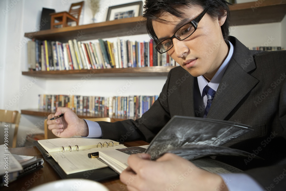 Businessman Writing In A Book