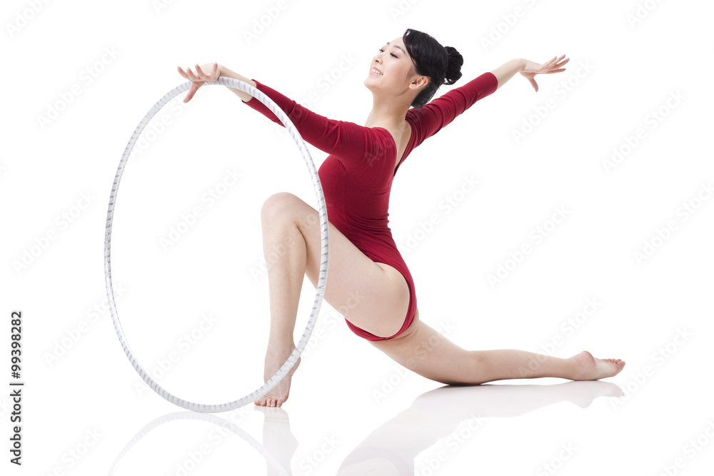 Female rhythmic gymnast performing with hoop