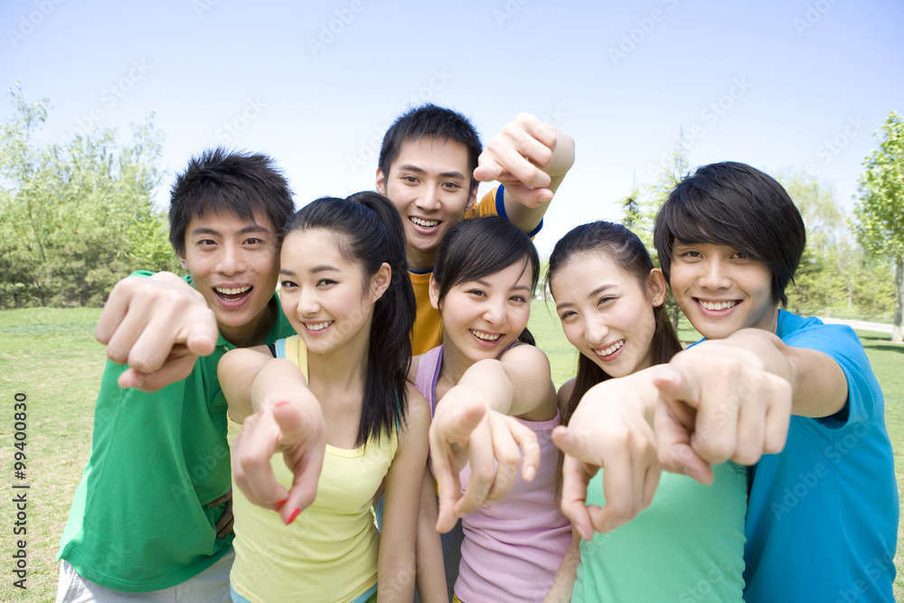 Group of friends pointing at the camera