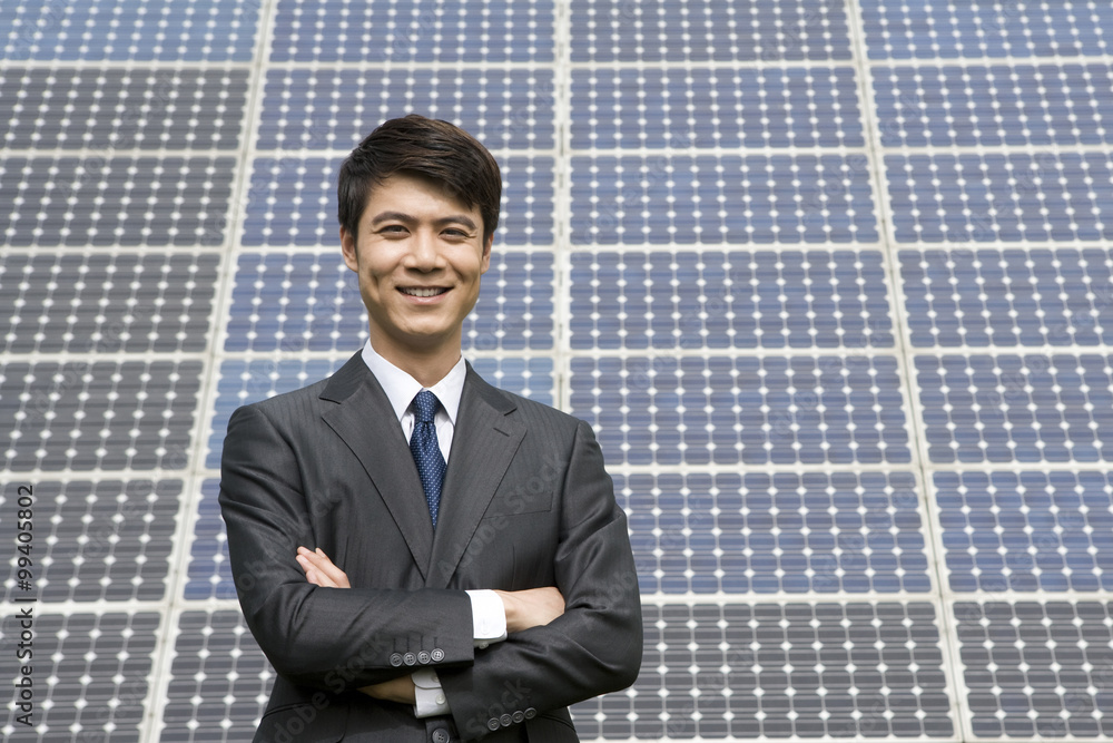 Portrait of a businessman in front of solar panels