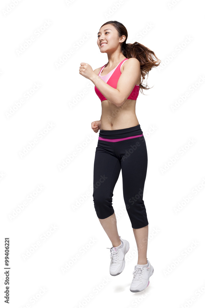 Young woman in sports clothing jumping