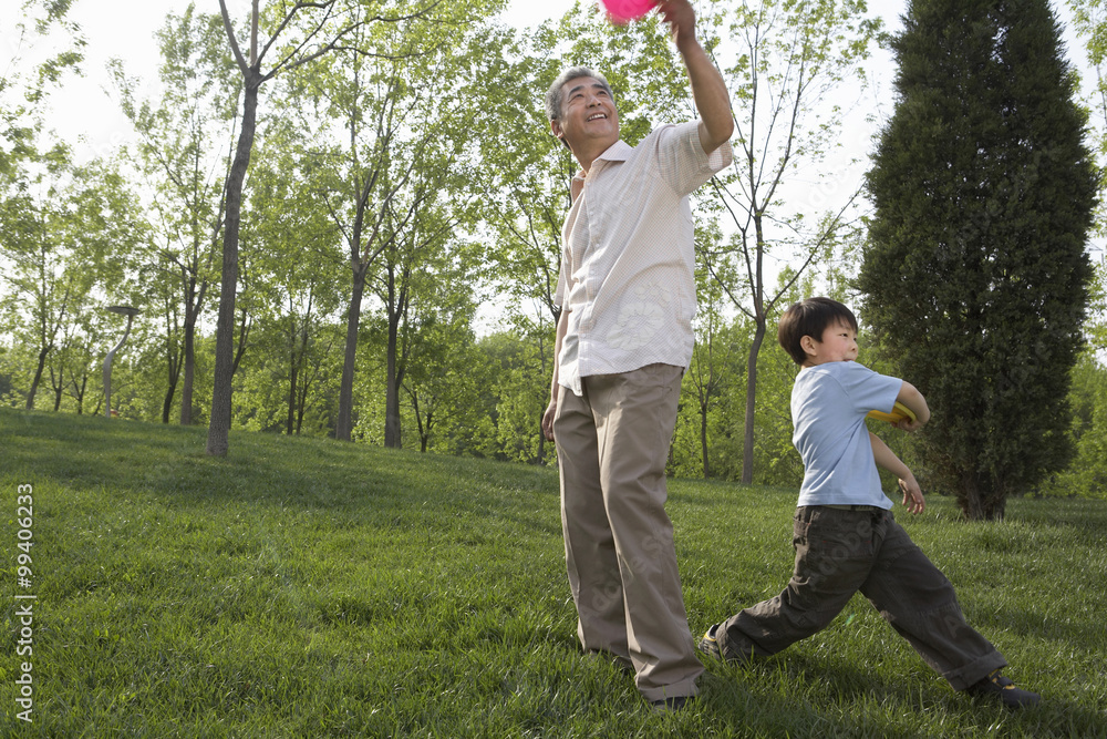 Man And Boy Playing In The Park