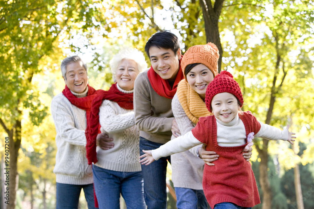 Three Generation Family Playing in a Park in Autumn