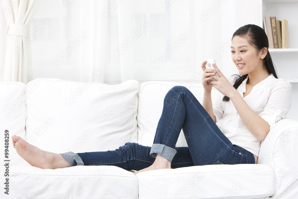 Young woman using phone at home