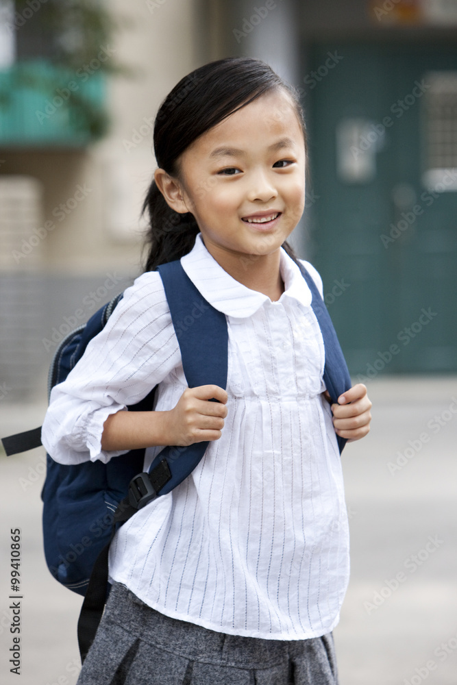 Portrait of smiling girl with schoolbag