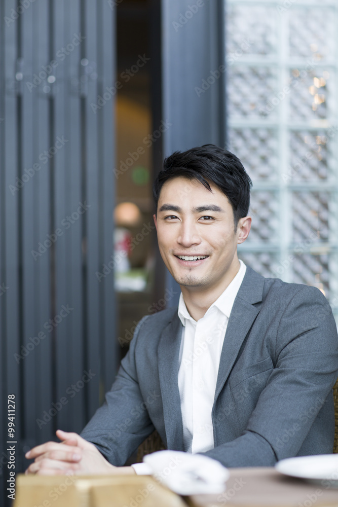 Young man sitting in restaurant