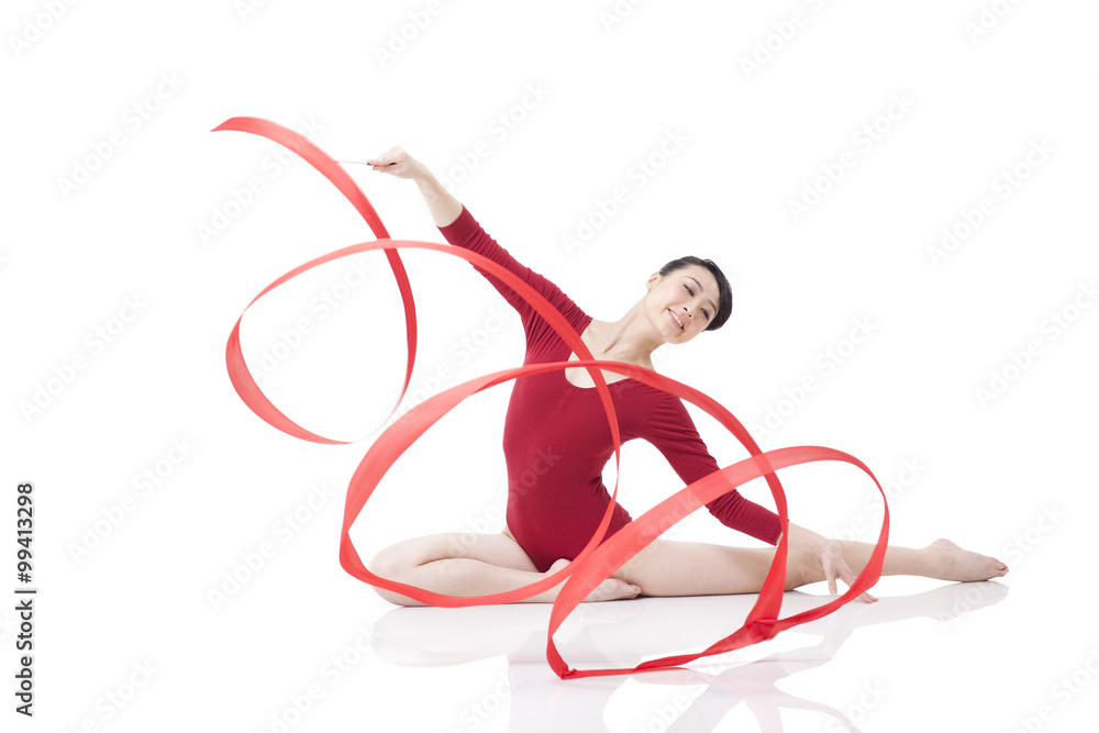 Female gymnast performing rhythmic gymnastics with ribbon