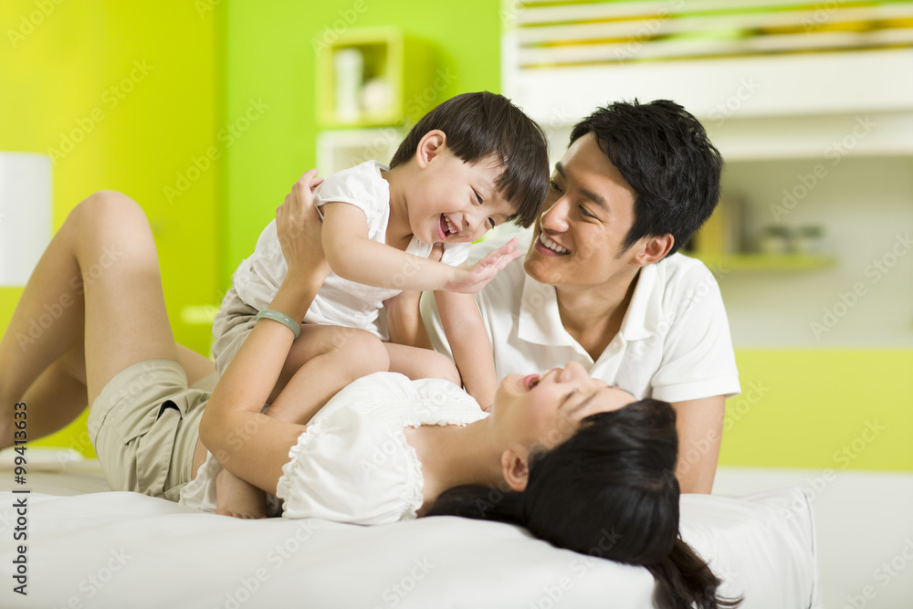 Happy family playing in bedroom