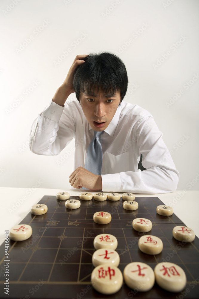 Office worker playing Chinese chess